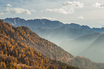 Autumn mountain view on the  foggy and sunny day in the Julian Alps, Europe