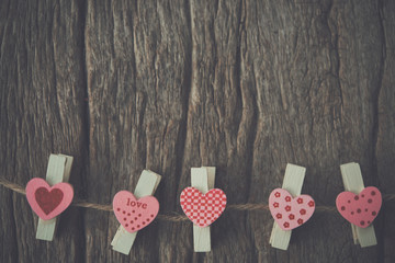 Red heart hanging on the clothesline for Valentines Day with copy space vintage style