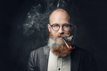 A man smoking pipe over grey background.