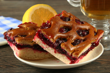 Homemade cherry pie on a wooden table.