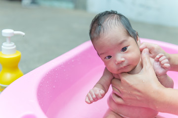 Fototapeta na wymiar Closeup asian baby take a shower