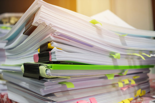 Paper stack, Pile of unfinished documents on office desk related to business functions. Stack of business papers for Annual Report files, Document is written,drawn,presented. Business offices concept.