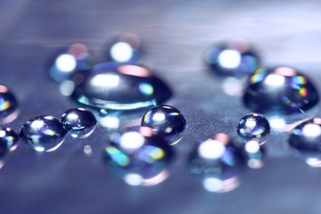 Drops on the glass with reflection. Abstract macro with colorful drops.