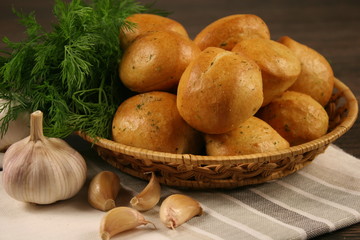 Homemade buns with garlic and dill on wooden table. Selective focus.