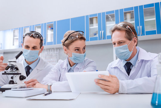 Scientists working with digital tablet