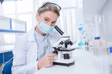 Scientist working with microscope