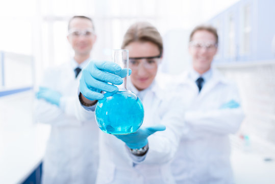 doctor showing flask with reagent