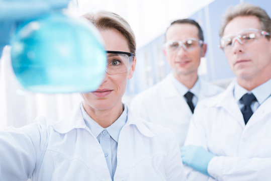 doctor showing flask with reagent