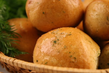 Homemade buns with garlic and dill on wooden table. Selective focus.