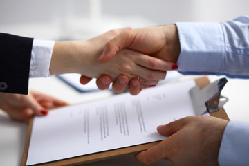 Business people shaking hands, finishing up a meeting, selective focus
