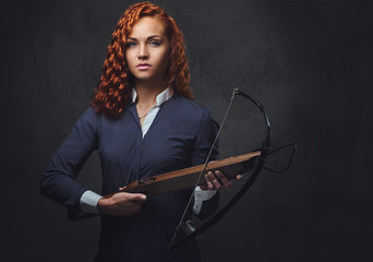 Redhead female  holds crossbow.