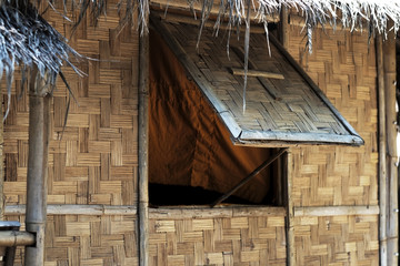 traditional vintage bamboo house in northern of thailand. Open the window because of the heat and...