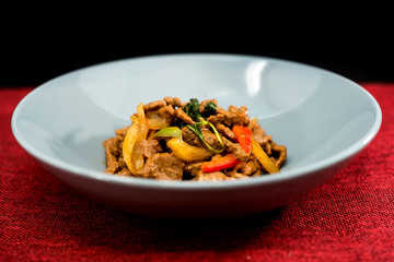 wok fried chicken stir fry with sweet peppers and chinese vegetables