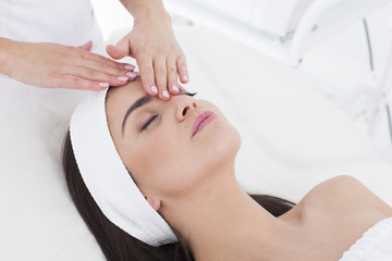 Fototapeta na wymiar Beautiful woman in Spa having a facial massage.