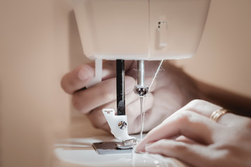 ailoring Process - Women's hands behind her sewing