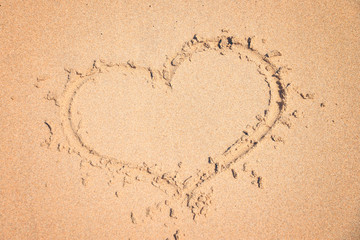 love, drawing on pure sand