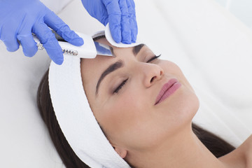 Woman in spa having a facial treatment.