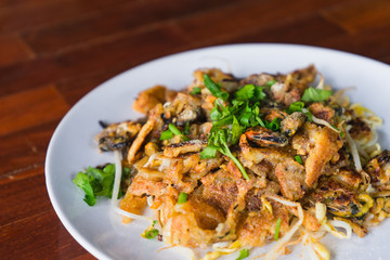 Thai traditional food hoy tod or fried mussel with bean sprout.