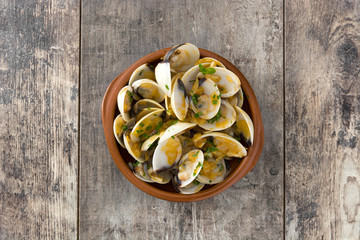 Clams with marinera sauce.Almejas a la marinera. Spanish recipe on wooden table.Top view