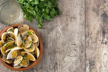Clams with marinera sauce.Almejas a la marinera. Spanish recipe on wooden table.Top view