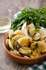 Clams with marinera sauce.Almejas a la marinera. Spanish recipe on wooden table