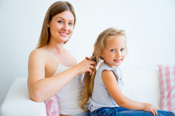 Mother and daughter taking care of hair