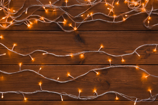 Christmas lights on wood background