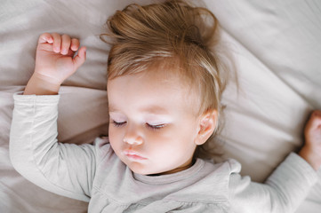 Beautiful toddler sleeping in bed