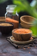 Wooden Bowl full of red lentils.