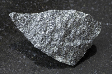 raw dolerite stone on dark background