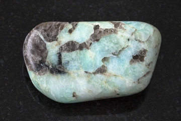 tumbled Pegmatite stone on dark background