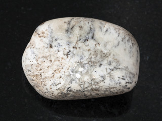 tumbled Albite gemstone on dark background