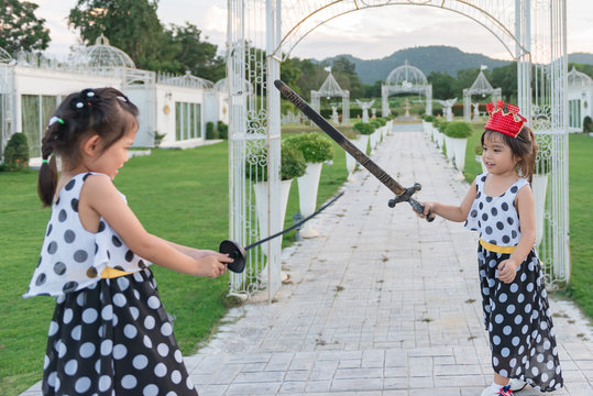Children playing fencing in the park with fun