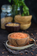 Wooden Bowl full of red lentils.