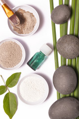 Cosmetic clay beside zen stones, natural cosmetics products concept