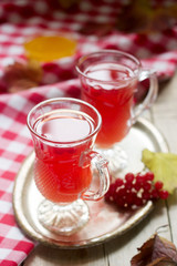 Useful vitamin tea from berries of the viburnum with honey with glass cups.