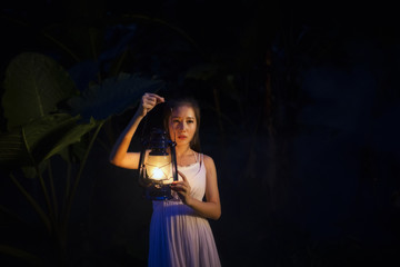 Beautiful woman holding lantern light