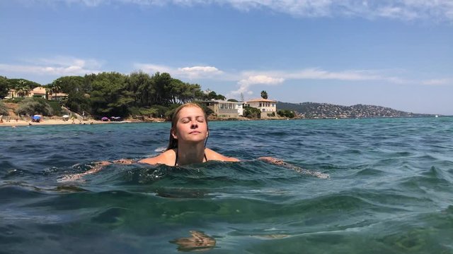 Caucasian female on in the sea French riviera footage - Swimming in crystal clear water 