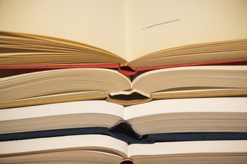 Several textbooks with white sheets opened in the middle
