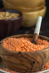 Wooden Bowl full of red lentils.