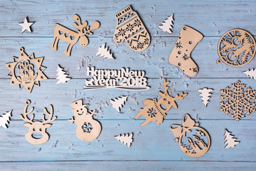 Christmas wooden with hanging toys and "Merry Xmas" greeting text written with small letters