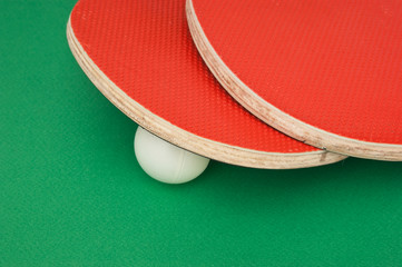tennis racquets on  green table