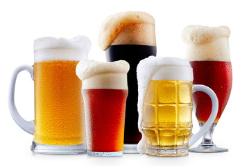 Mug collection of frosty dark red and light beer with foam isolated on a white background