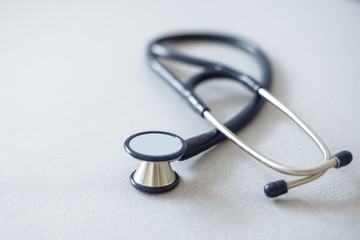 Phonendoscope - medical diagnostic tool on a gray background. Shallow depth of field