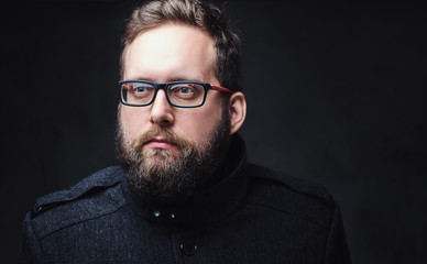 Fototapeta premium Serious plump male in eyeglasses over grey background.