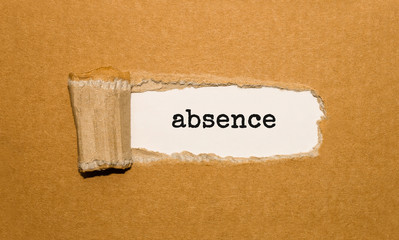 The text Absence appearing behind torn brown paper