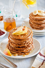Stacks Of Whole Wheat Pancakes With Apple And Banana Slices