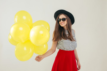 Young pretty woman with yellow balloons
