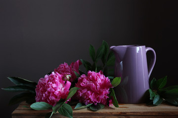 Pink peonies and a pitcher.