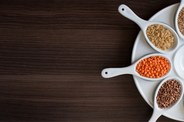 Cereals in a white dish on a dark wooden background